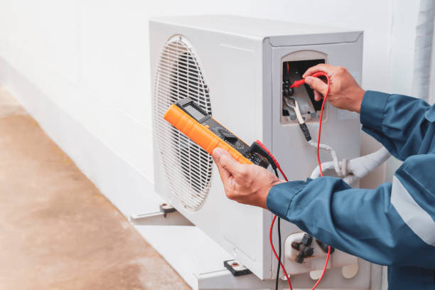 Technician testing an HVAC system with a multimeter
